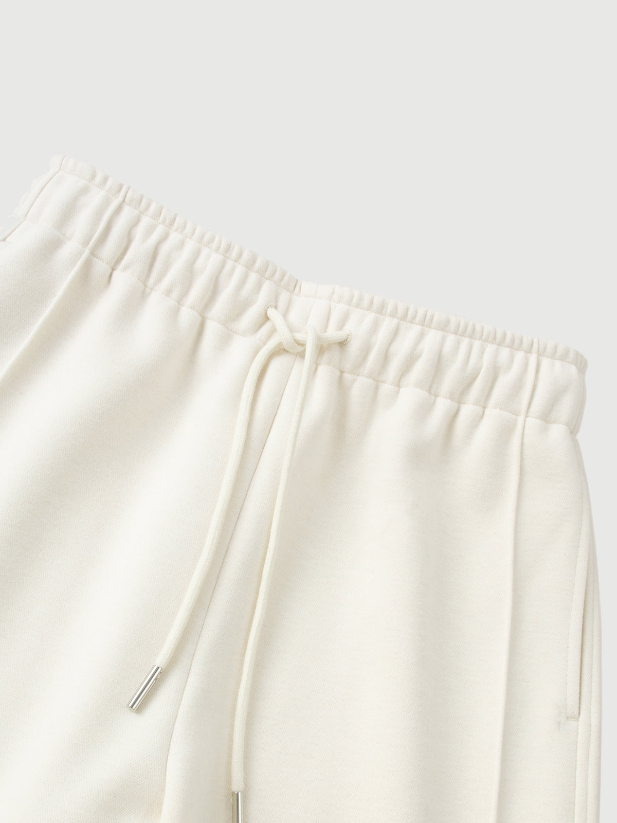 White pants with an elastic waistband on a light gray background