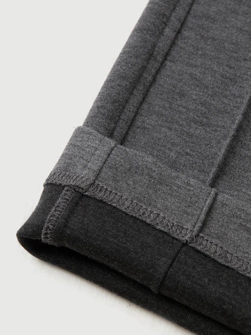 Load image 1 in gallery view. Close-up of gray sweatpants with a white background