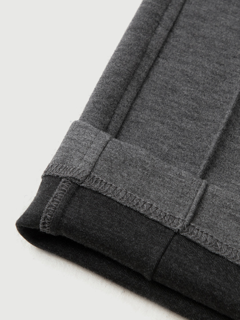 Close-up of gray sweatpants with a white background