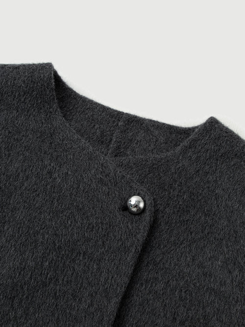 Load image 1 in gallery view. Close-up of a dark gray textured garment with a button