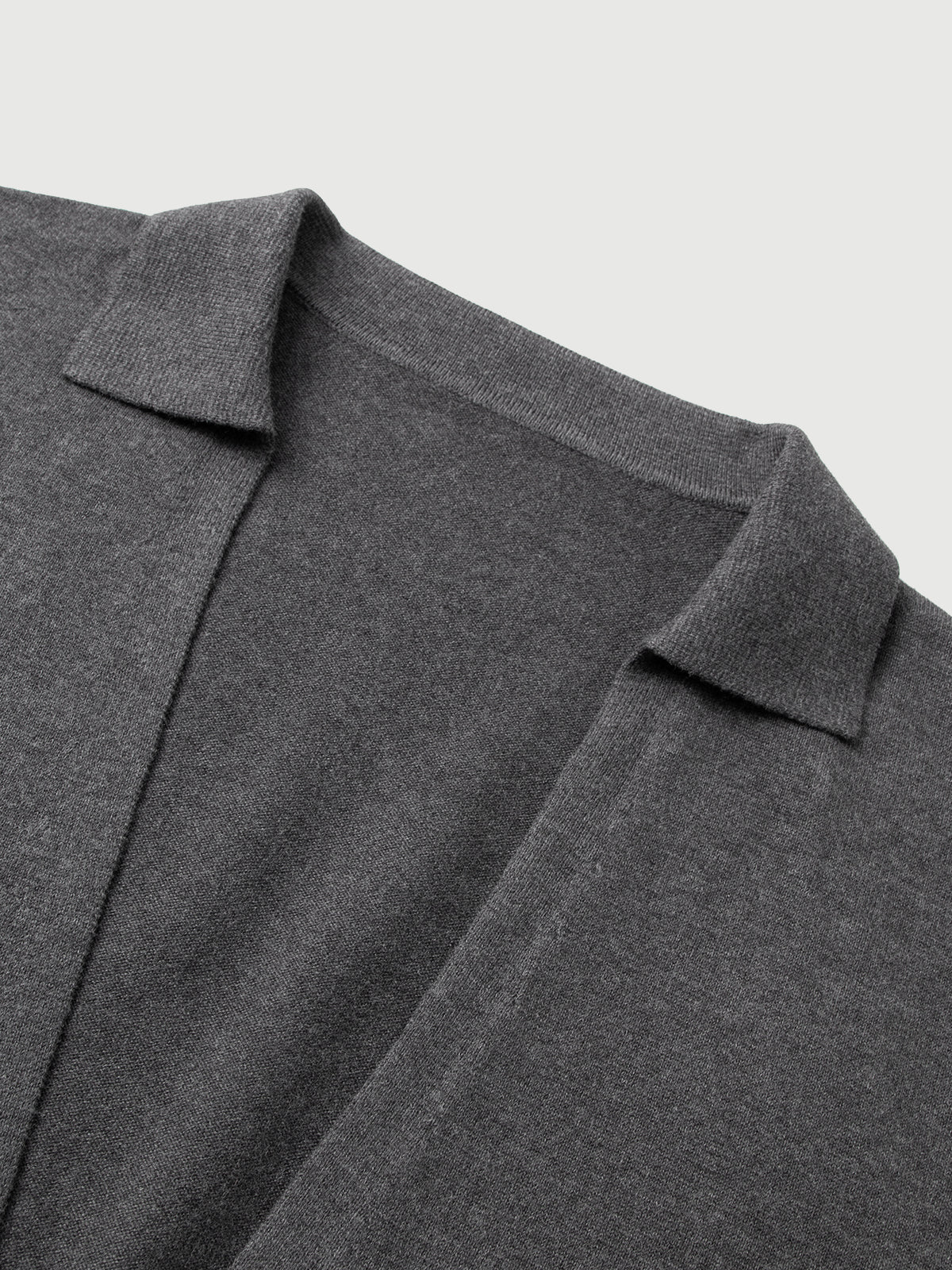 Close-up of a gray sweater with a collar on a light gray background