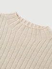Close-up of a beige ribbed sweater on a light gray background