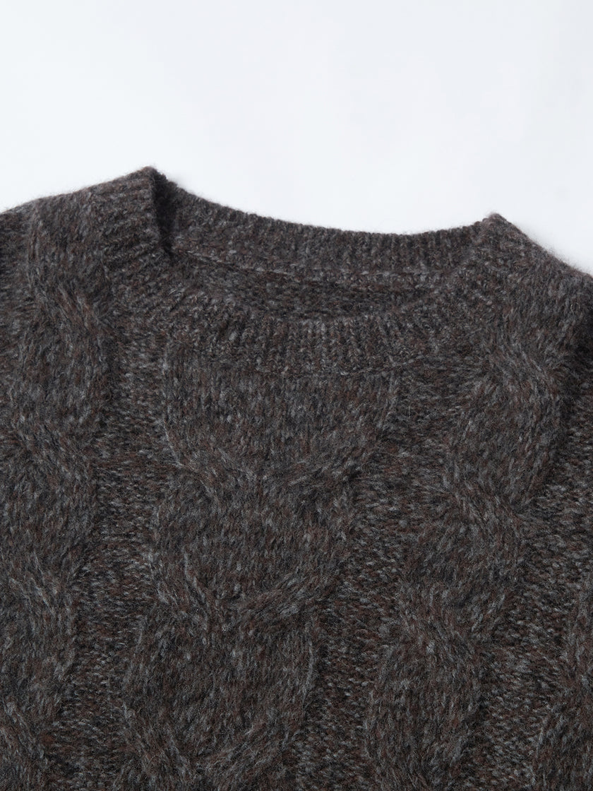 Close-up of a dark gray cable knit sweater on a white background