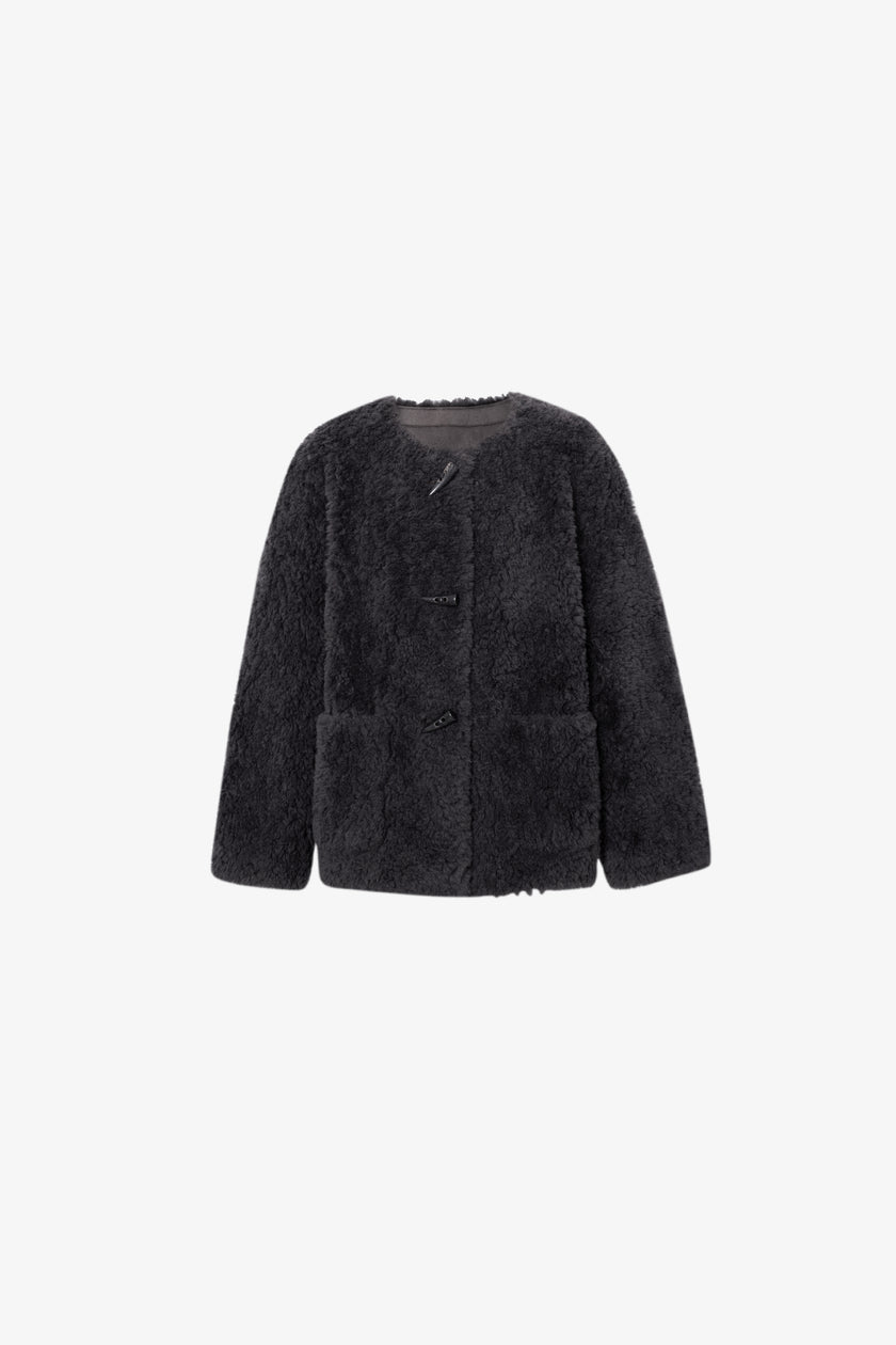 Black fluffy jacket on a white background