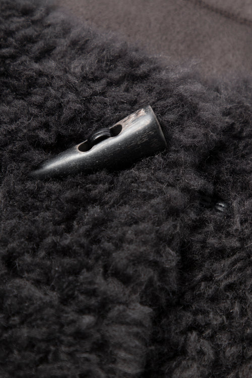 Load image 1 in gallery view. Close-up of a button on a dark textured fabric