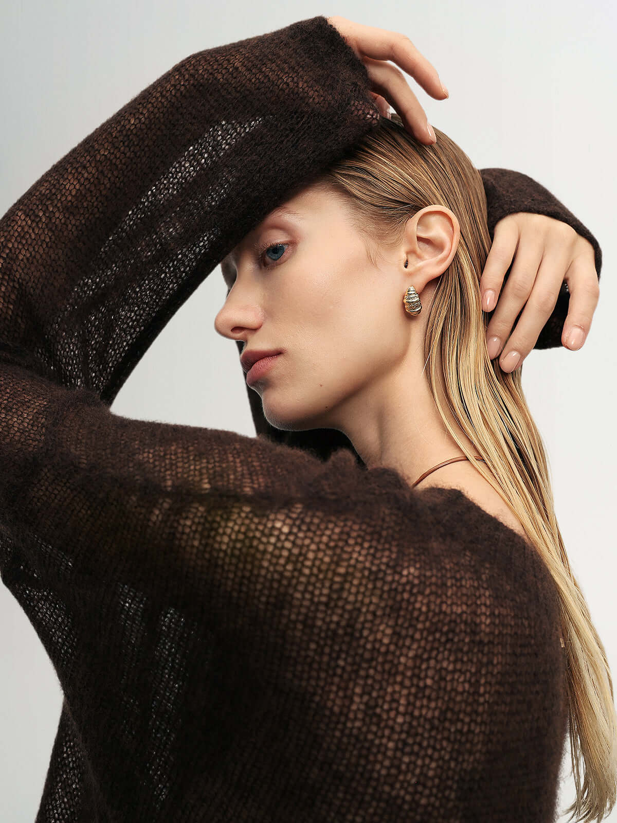 Cashmere-Silk Relaxed Pullover Sweater in dark brown worn by a model with natural beauty and subtle jewelry.