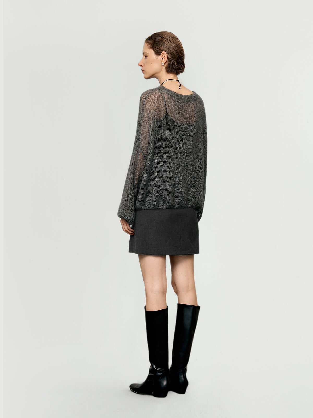 Cashmere-Silk Relaxed Pullover Sweater shown from the back, paired with a mini skirt and knee-high boots.
