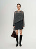 Cashmere-Silk Relaxed Pullover Sweater styled with a short gray skirt and knee-high boots.