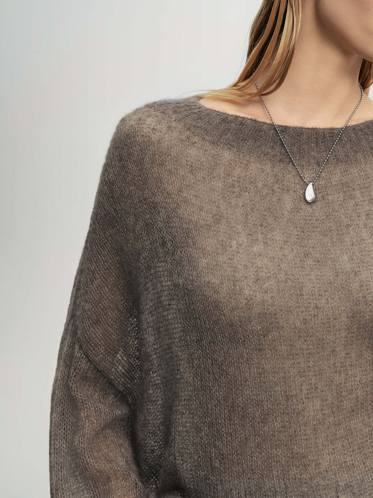 Close-up of a woman wearing a Cashmere-Silk Relaxed Pullover Sweater with dropped shoulders and a delicate necklace.