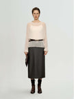 Model wearing a Cashmere-Silk Relaxed Pullover Sweater with a leather skirt and belt, showcasing elegant style.