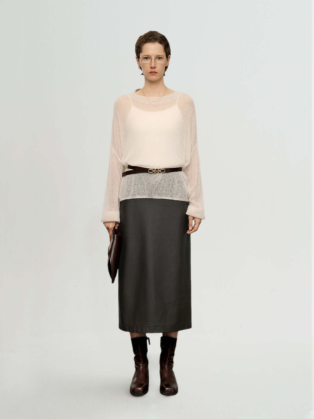 Model wearing a Cashmere-Silk Relaxed Pullover Sweater with a leather skirt and belt, showcasing elegant style.