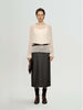 Model wearing a Cashmere-Silk Relaxed Pullover Sweater with a leather skirt and belt, showcasing elegant style.