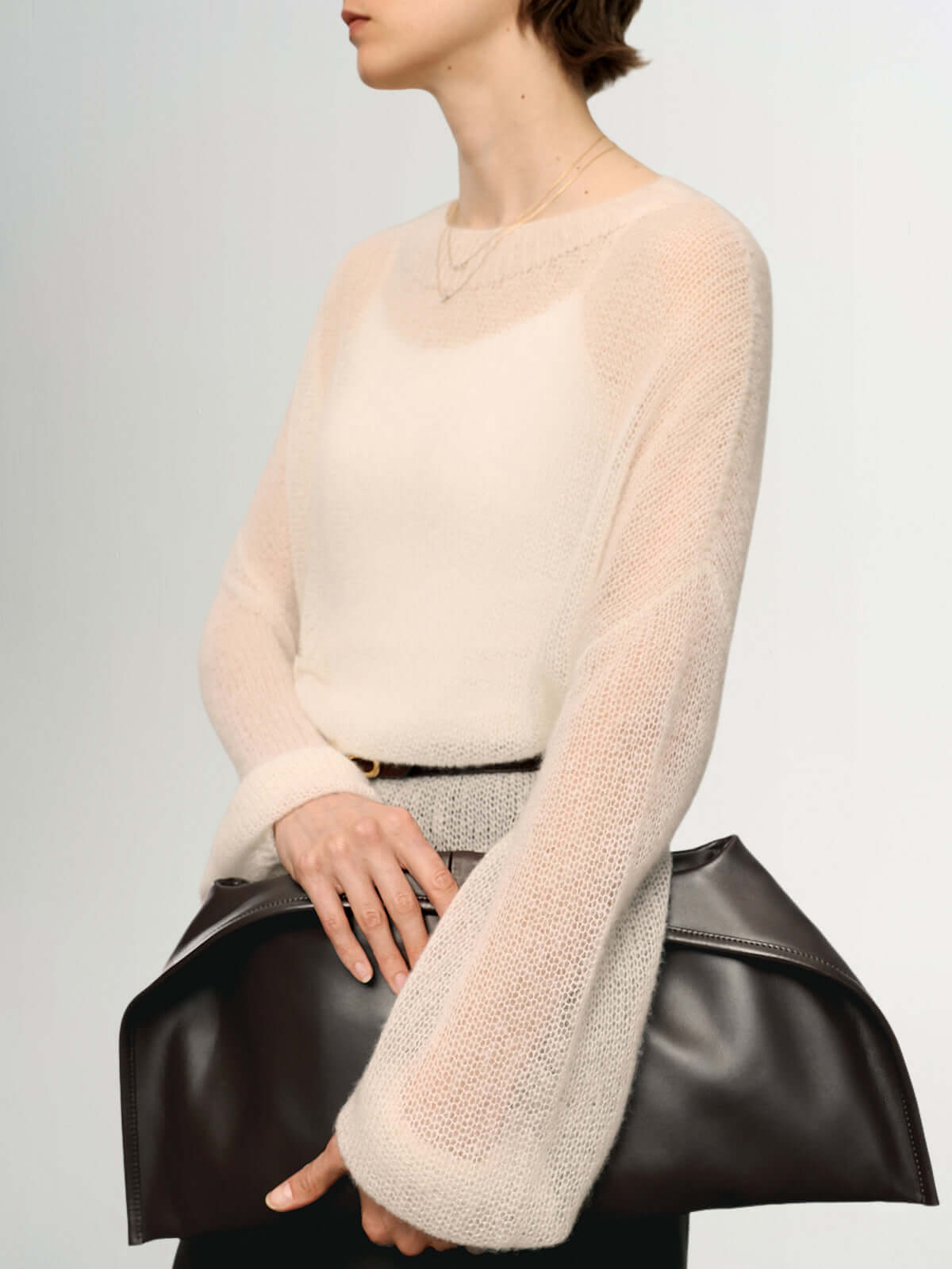 Cashmere-Silk Relaxed Pullover Sweater worn with a large brown handbag, showcasing a soft and elegant style.