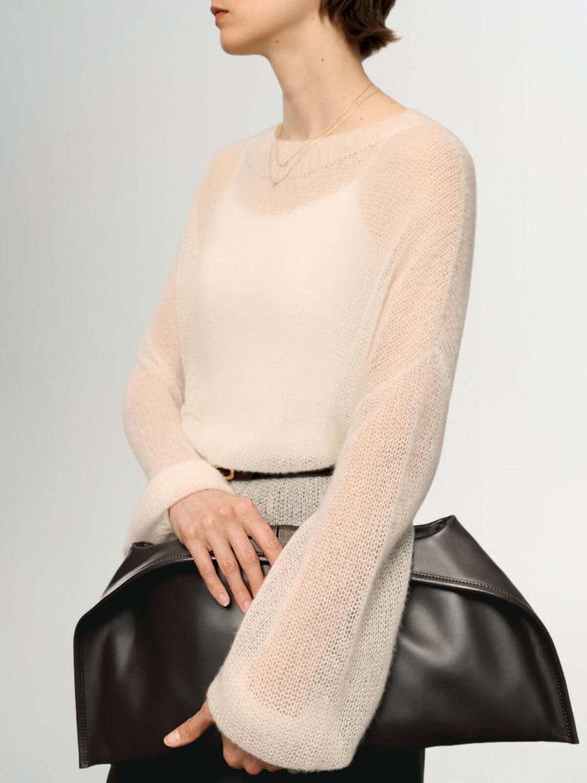 Cashmere-Silk Relaxed Pullover Sweater worn with a large brown handbag, showcasing a soft and elegant style.