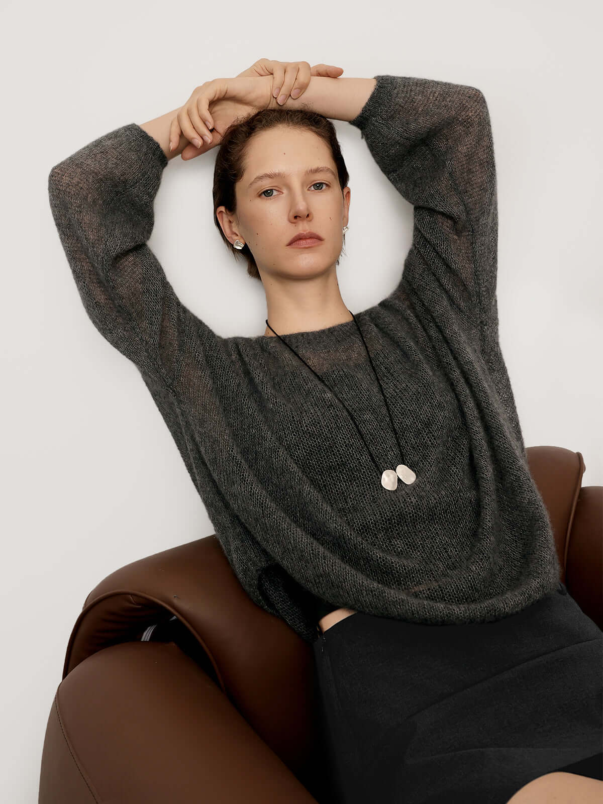 Cashmere-Silk Relaxed Pullover Sweater model wearing gray sweater and black skirt, showcasing relaxed style and elegance.