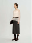 Cashmere-Silk Relaxed Pullover Sweater worn with a dark skirt, showcasing its elegant drape and versatile styling.
