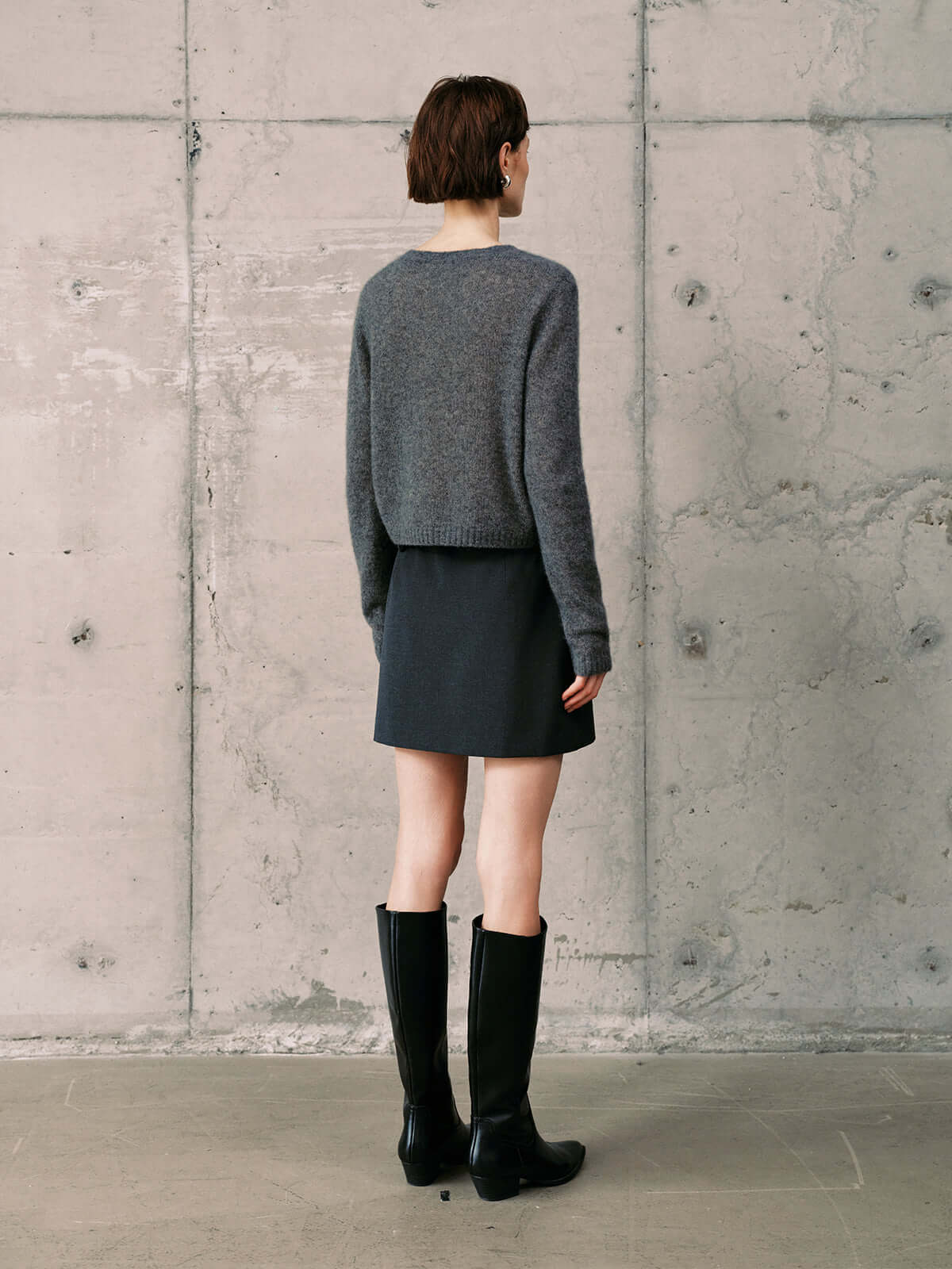 Silk-Cashmere Cardigan worn with a skirt and knee-high boots, showcasing a stylish, neutral outfit.