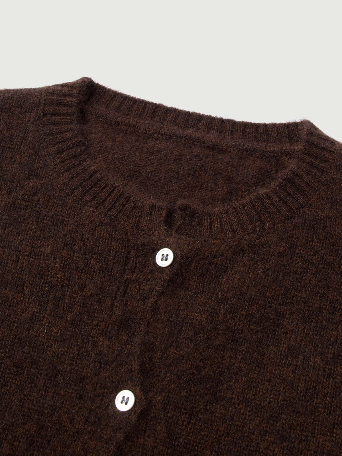Silk-Cashmere Cardigan in dark brown, showcasing soft fabric and button details, perfect for layering.