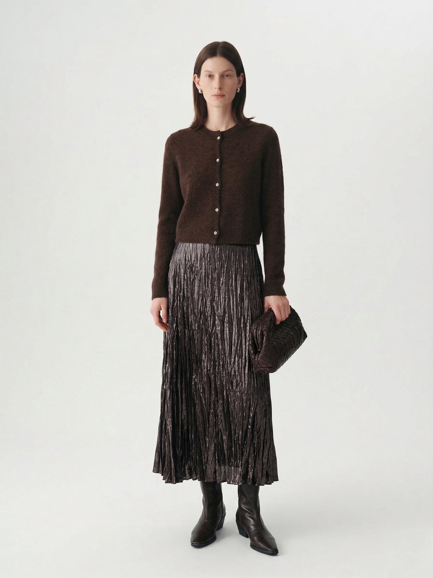 Silk-Cashmere Cardigan worn with a pleated skirt, showcasing its soft texture and versatile style.
