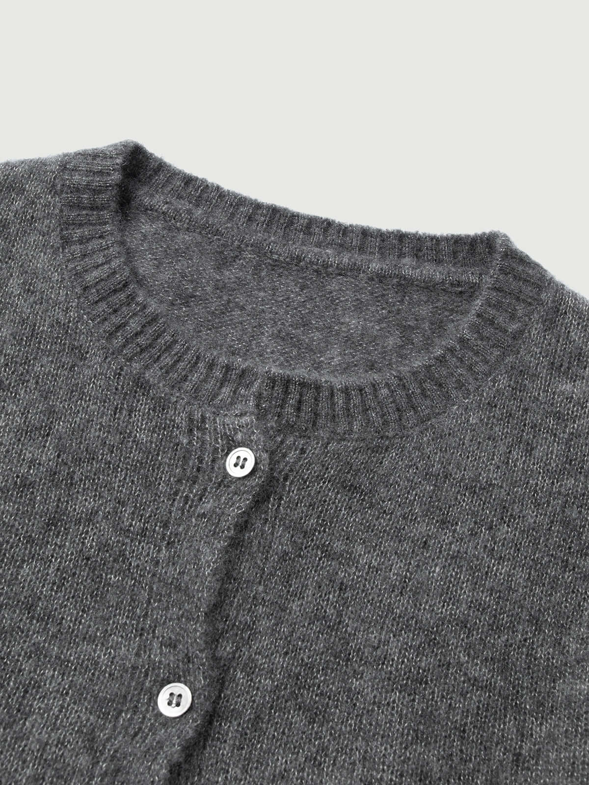 Silk-Cashmere Cardigan with a textured gray knit and button details, perfect for layering in tropical climates.