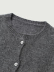 Silk-Cashmere Cardigan with a textured gray knit and button details, perfect for layering in tropical climates.