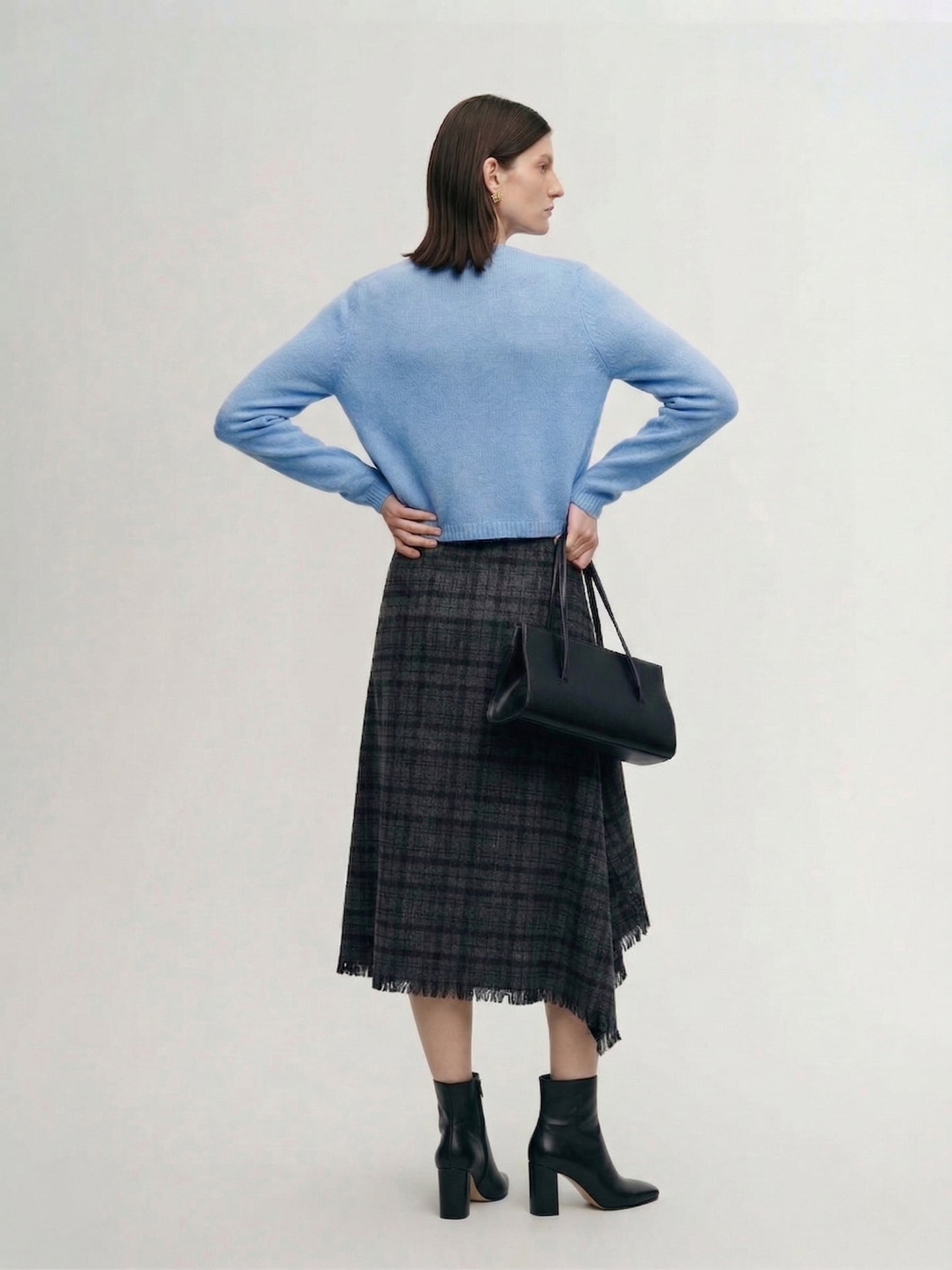 Silk-Cashmere Cardigan in soft blue color, showcasing lightweight and cozy design perfect for tropical climates.