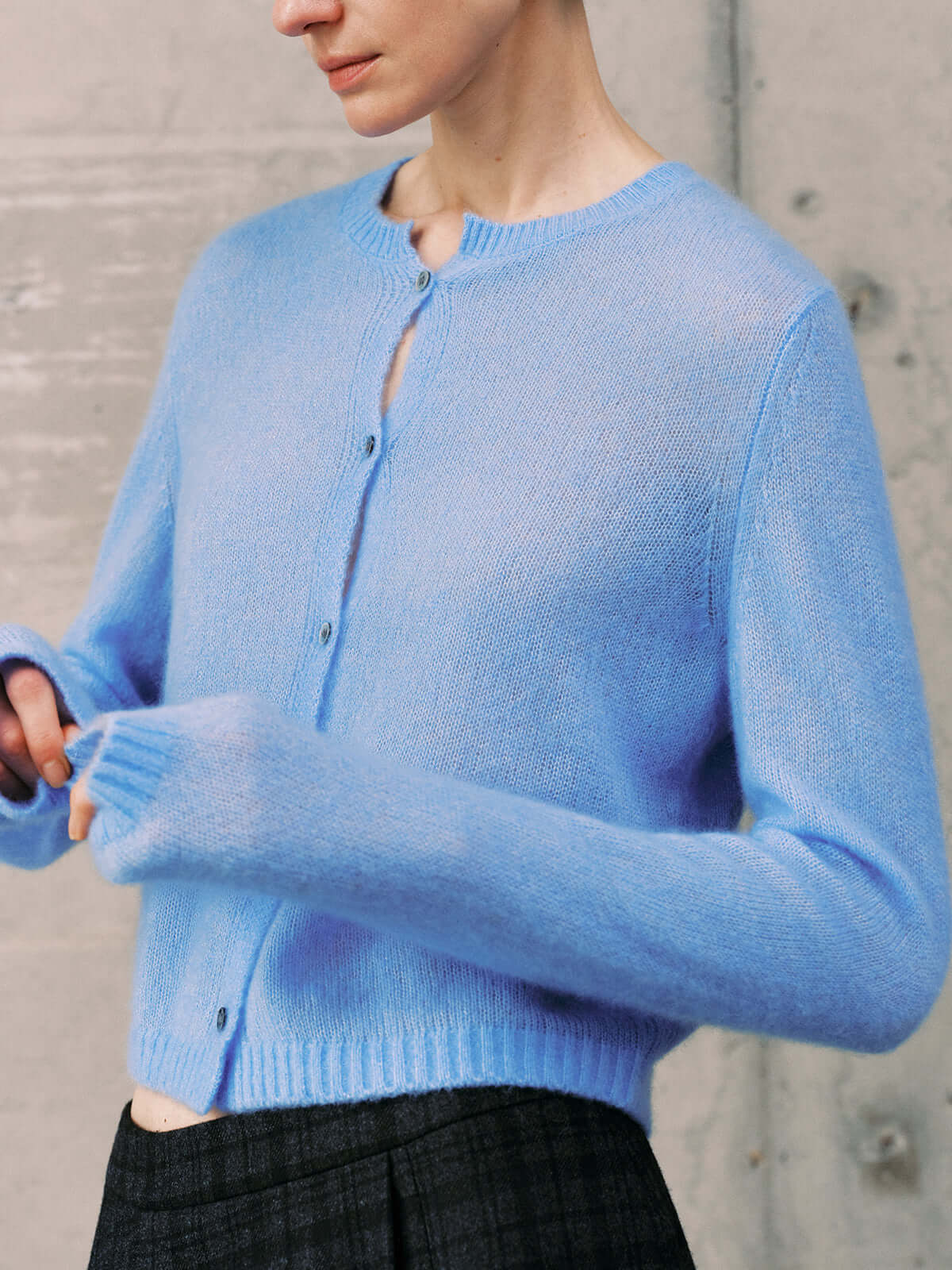 Silk-Cashmere Cardigan in soft blue color, showcasing lightweight and cozy design perfect for tropical climates.