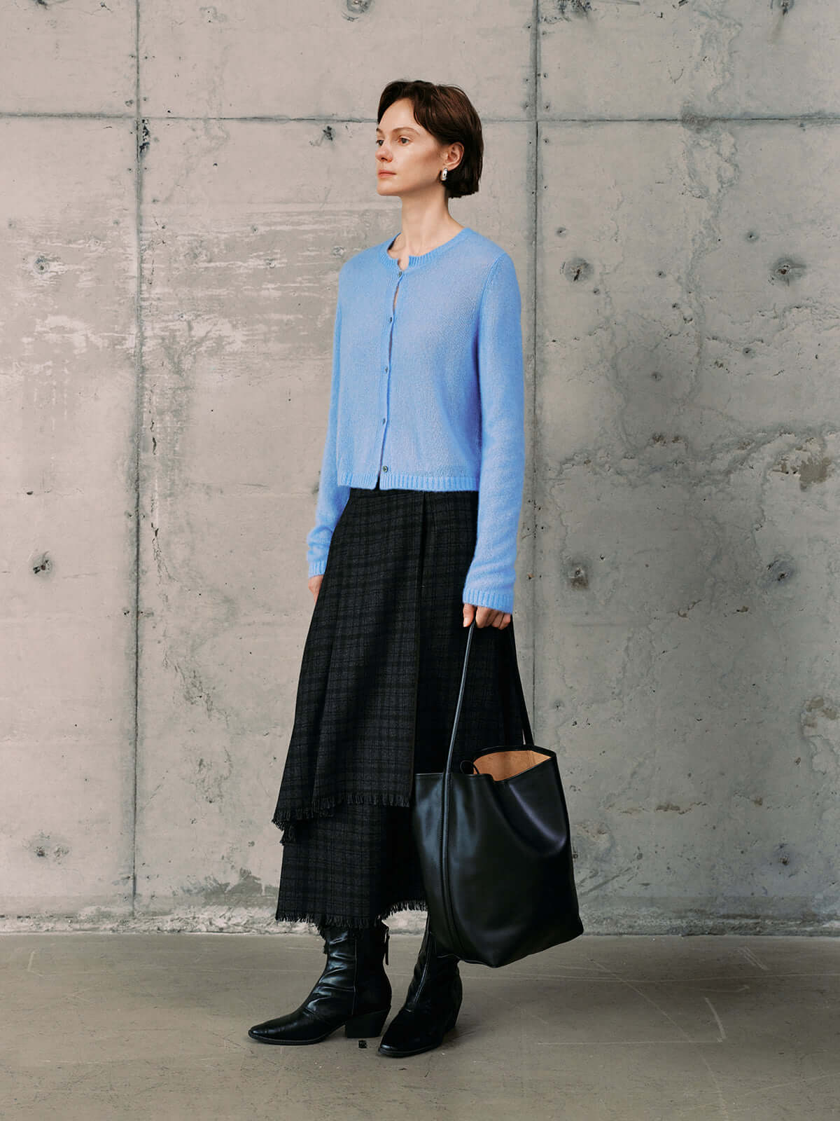 Model wearing a Silk-Cashmere Cardigan with a long skirt and black boots, showcasing versatile styling options.