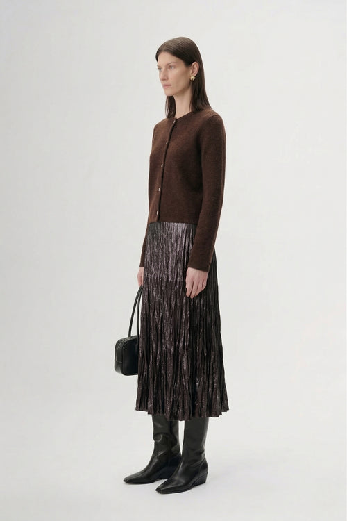 Load image 1 in gallery view. Silk-Cashmere Cardigan styled with a pleated metallic skirt and knee-high boots in a modern interior.