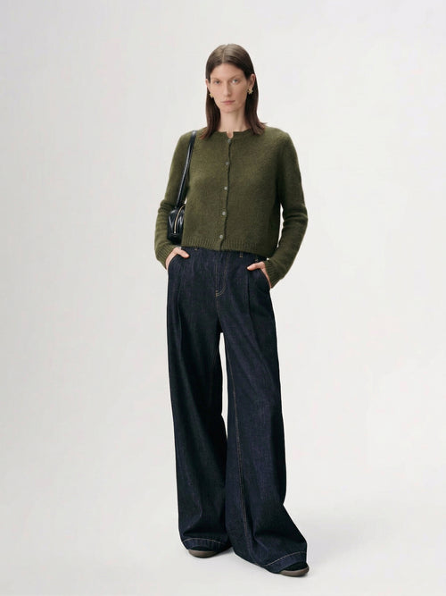 Load image 1 in gallery view. Silk-Cashmere Cardigan styled with wide-leg jeans in a modern, minimalistic setting.