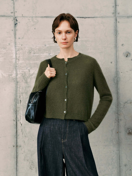 Load image 1 in gallery view. Silk-Cashmere Cardigan in olive green worn by a model with a black bag, perfect for tropical climates and versatile styling.