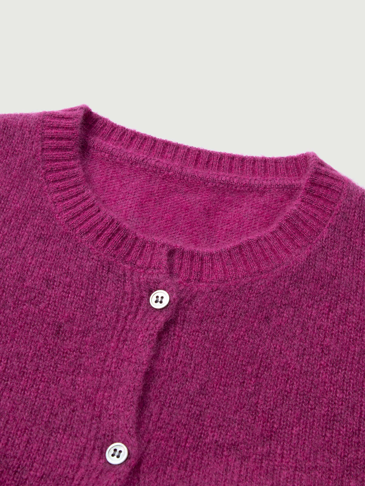 Silk-Cashmere Cardigan in vibrant pink, featuring a round neckline and button closure, perfect for layering.
