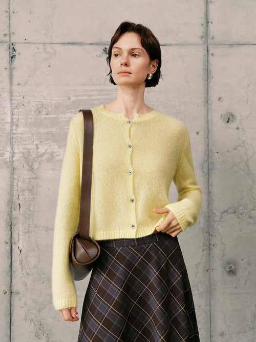 Load image 1 in gallery view. Silk-Cashmere Cardigan styled with a plaid skirt, showcasing a soft yellow hue and lightweight design.