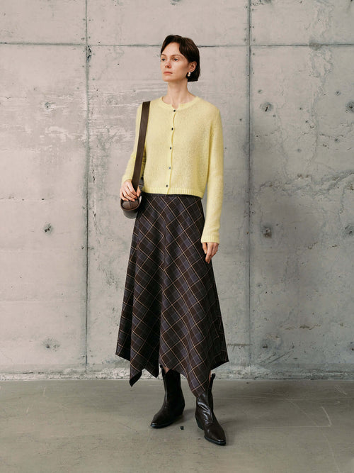 Load image 1 in gallery view. Silk-Cashmere Cardigan styled with a patterned skirt and boots against a minimalist background.