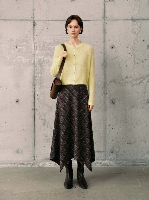 Load image 1 in gallery view. Model wearing a Silk-Cashmere Cardigan with a patterned skirt and boots, showcasing a stylish and comfortable outfit.