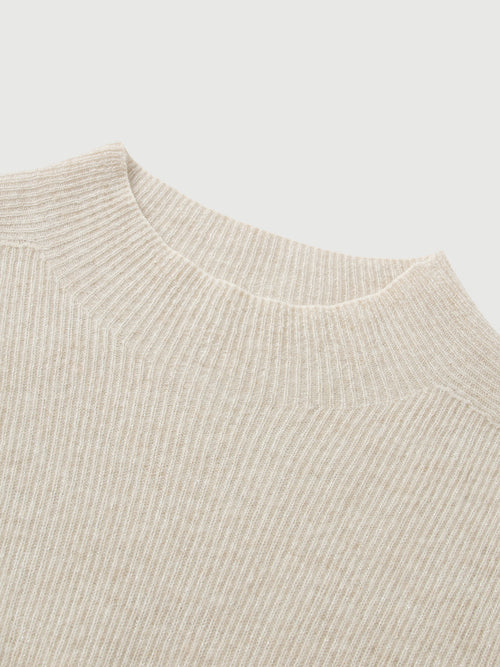Load image 1 in gallery view. Close-up of a beige knit sweater on a light gray background