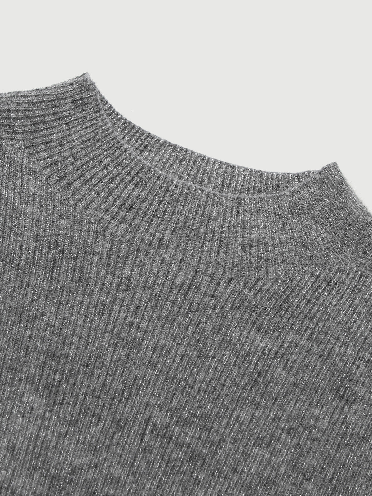 Close-up of a gray ribbed sweater collar on a light gray background