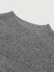 Close-up of a gray ribbed sweater collar on a light gray background